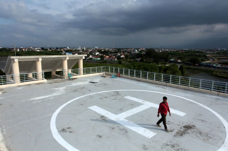 Man walks on a helipad of Tsunami Escape Building in Banda Aceh