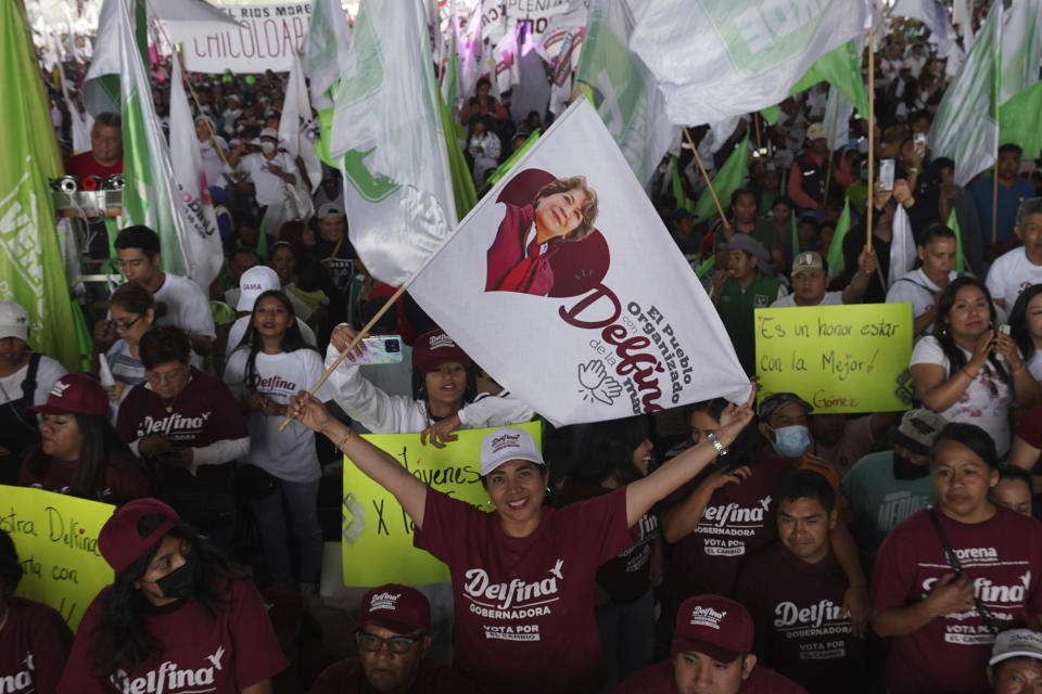 Supporters of MORENA party gubernatorial candidate Delfina Gomez cheer during a campaign rally in Valle de Chalco, Mexico state, Mexico, Sunday, May 28, 2023. Voters in the state of Mexico go to the polls on June 4 to elect a new governor. (AP Photo/Marco Ugarte)