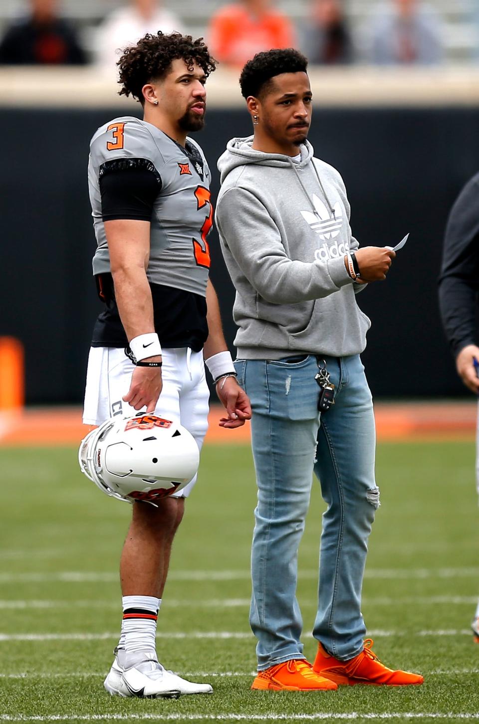 Former Cowboy quarterback Spencer Sanders, left, and receiver Tylan Wallace, right, were four-star recruits.