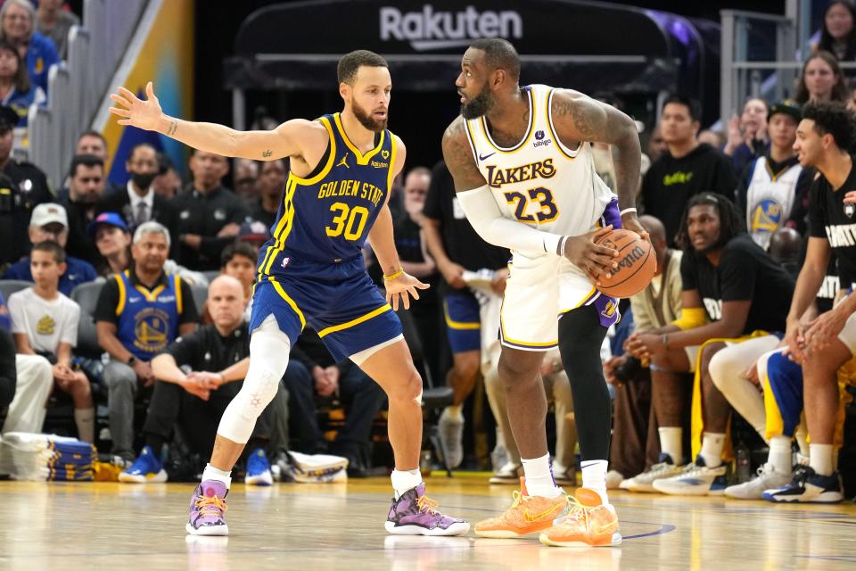 Warriors guard Stephen Curry defends against Lakers forward LeBron James during a game earlier this year.