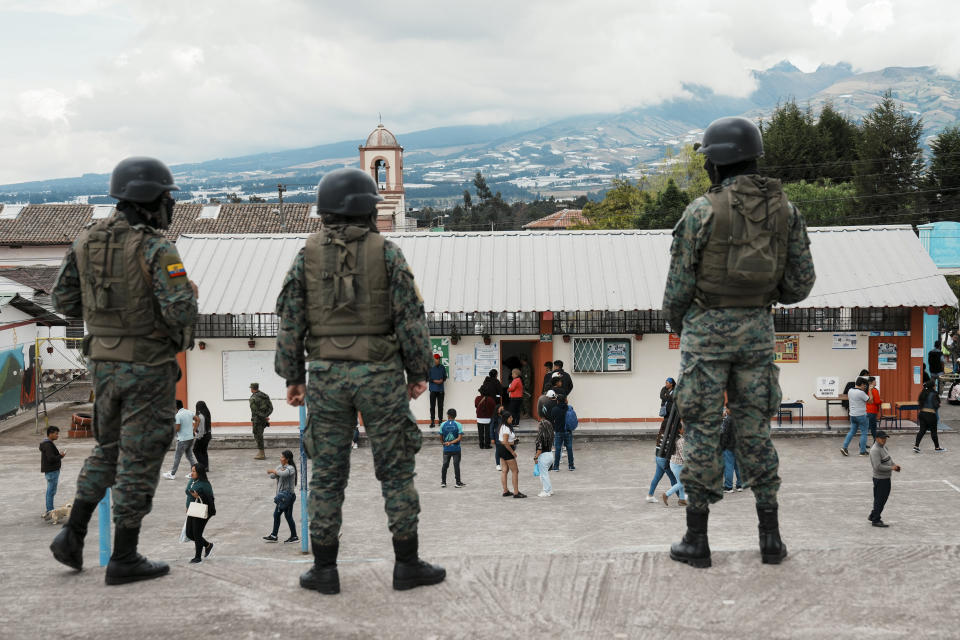 Soldiers guard a polling station during the snap presidential election in Ayora, Ecuador, Sunday, Aug. 20, 2023. The election was called after President Guillermo Lasso dissolved the National Assembly by decree in May to avoid being impeached. (AP Photo/Dolores Ochoa)