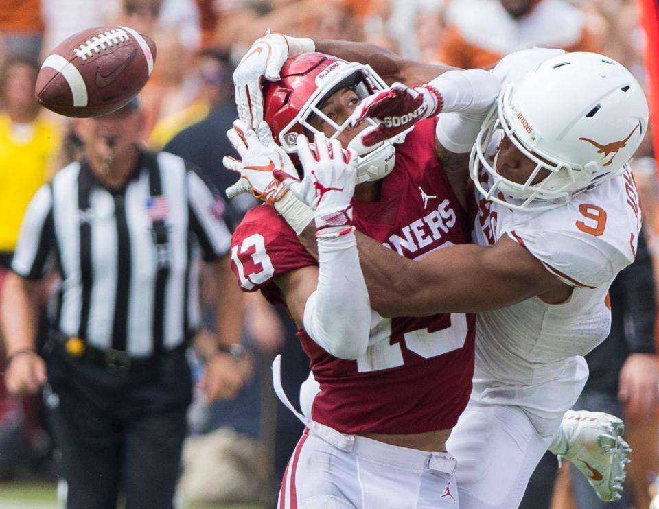 Texas wide receiver Collin Johnson and Oklahoma cornerback Tre Norwood collide on a pass play during the fourth quarter of the 2018 Texas-OU game at the Cotton Bowl. This year's matchup pits two 5-0 teams against each other Saturday.