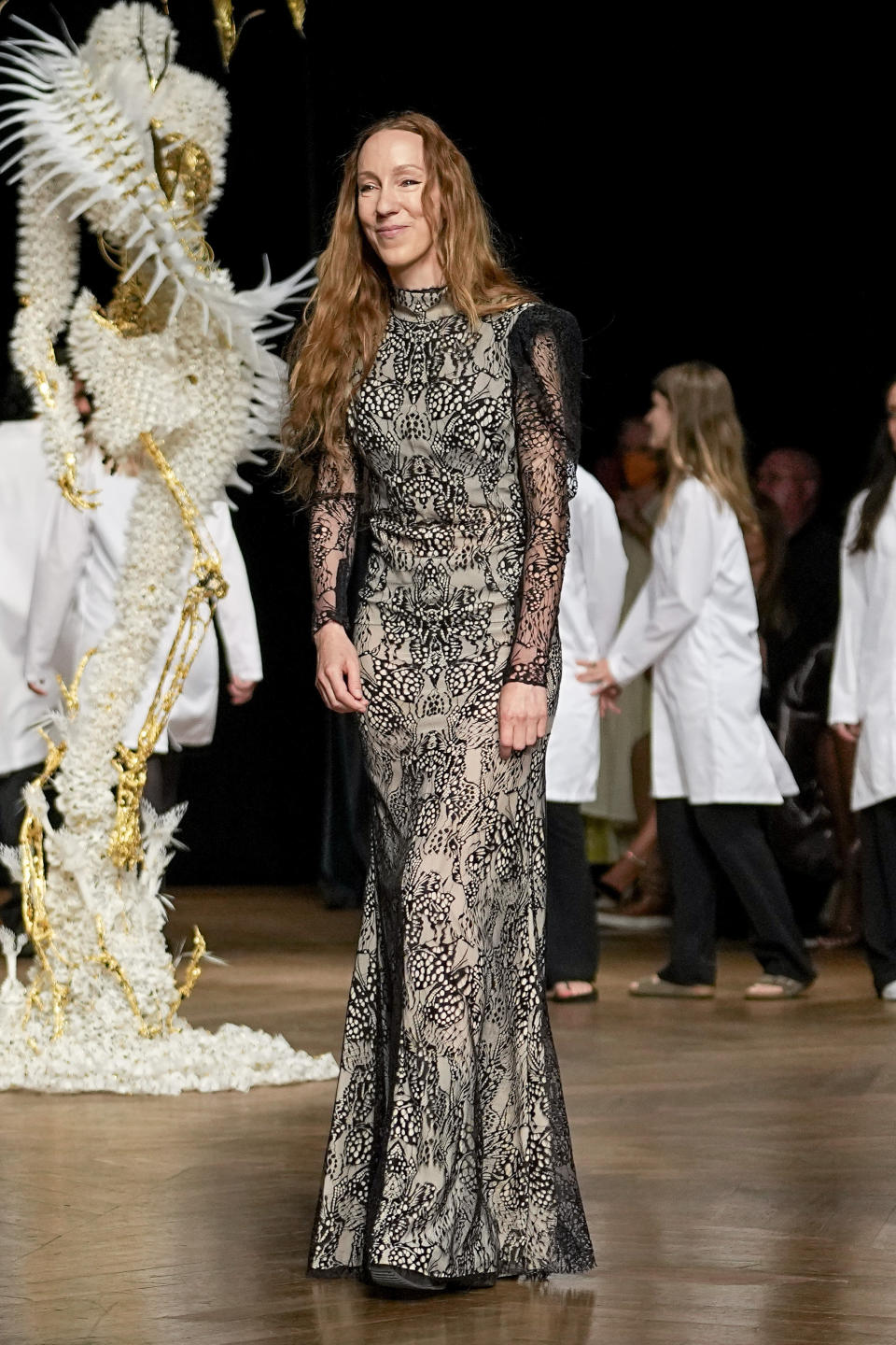 Designer Iris van Herpen accepts applause at the end of Iris van Herpen Haute Couture Fall/Winter 2022-2023 fashion collection presented Monday, July 4, 2022 in Paris. (AP Photo/Michel Euler)