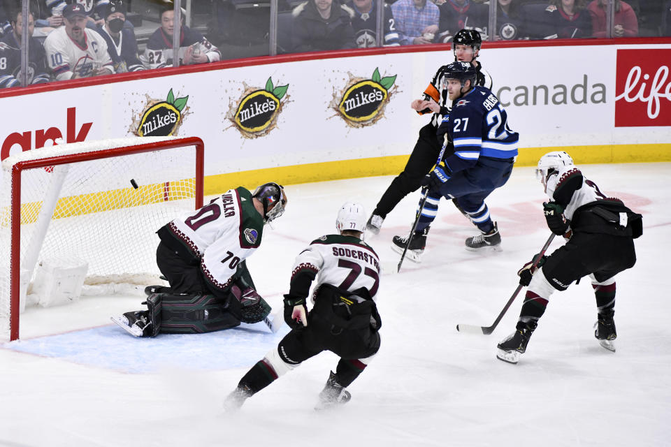 Winnipeg Jets' Nikolaj Ehlers (27) scores on Arizona Coyotes' goaltender Karel Vejmelka (70) during the first period of an NHL hockey game, Tuesday, March 21, 2023 in Winnipeg, Manitoba. (Fred Greenslade/The Canadian Press via AP)