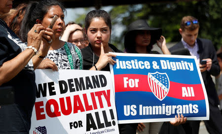 Demonstrators listen to Rev. Al Sharpton speak during a press conference in front of the U.S. Capitol to call on the Trump administration to stop separating children from their families at the U.S. border in Washington, U.S., June 19, 2018. REUTERS/Kevin Lamarque