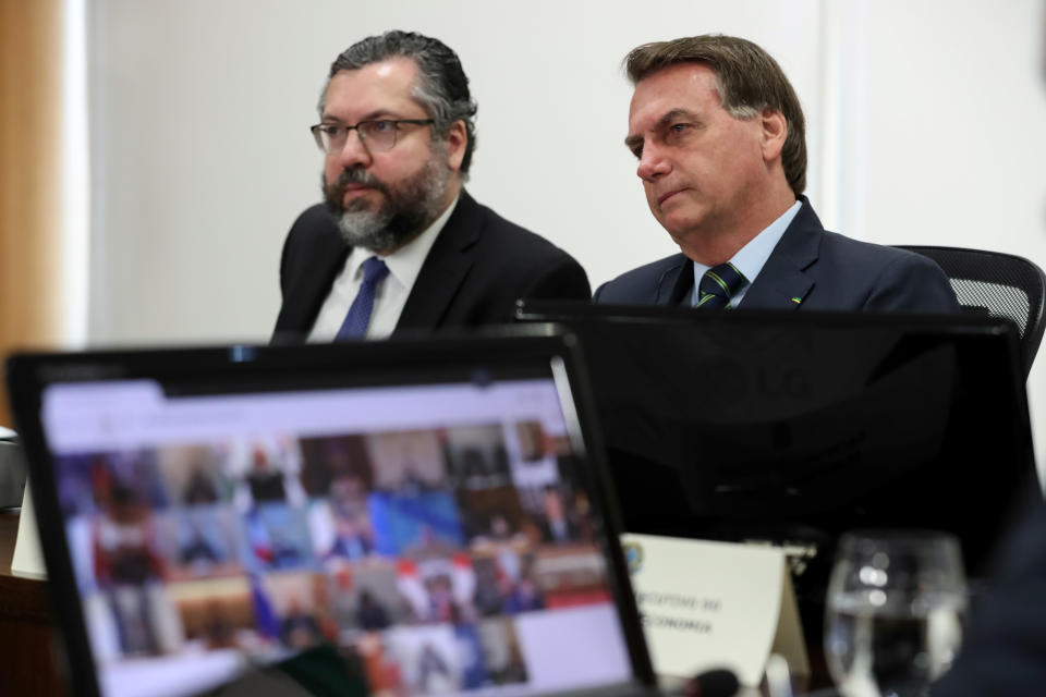 Brazil's President Jair Bolsonaro and Foreign Minister Ernesto Araujo take part in a video link, held by G20 leaders to discuss the coronavirus outbreak and its economic impacts, at the Planalto Palace in Brasilia, Brazil March 26, 2020. Marcos Correa/Brazilian Presidency/Handout via REUTERS ATTENTION EDITORS - THIS IMAGE WAS PROVIDED BY A THIRD PARTY.