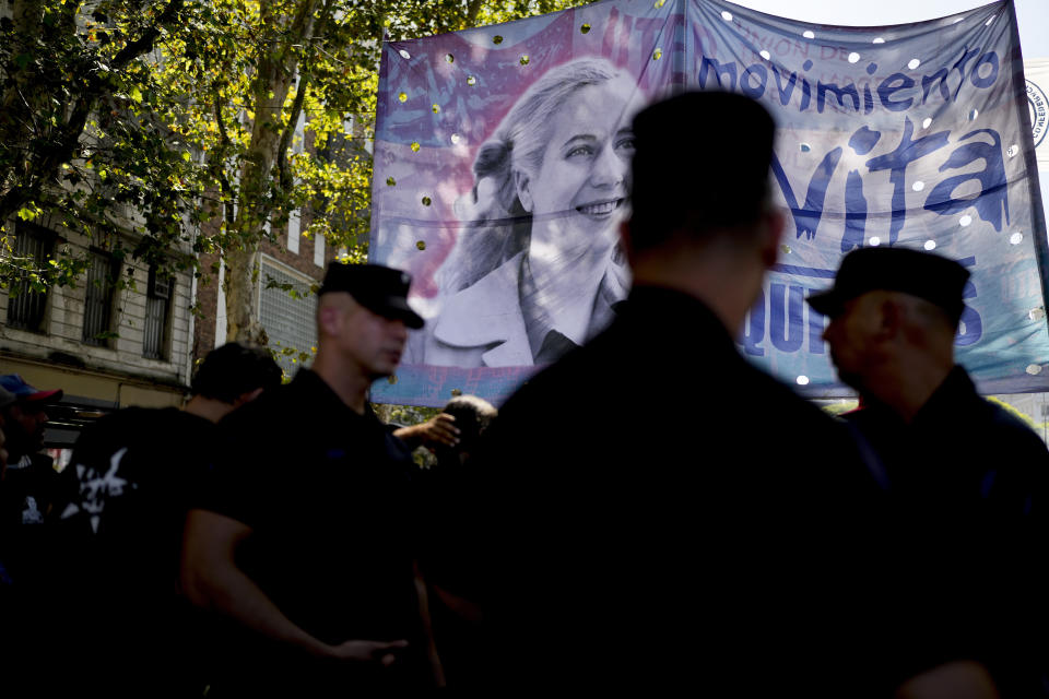 An Evita Movement banner featuring an image of Argentine former first lady María Eva Duarte de Perón, better known as Eva Perón, or Evita, towers over demonstrators and police at a rally and strike to protest the economic and labor reforms proposed by Argentine President Javier Milei, in Buenos Aires, Argentina, Wednesday, Jan. 24, 2024. (AP Photo/Natacha Pisarenko)