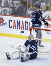 Winnipeg Jets goaltender Connor Hellebuyck (37) and Mark Scheifele (55) react after St. Louis Blues' Jaden Schwartz scored in final minute Game 5 of an NHL hockey first-round playoff series Thursday, April 18, 2019, in Winnipeg, Manitoba. (John Woods/The Canadian Press via AP)