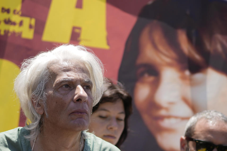 Pietro Orlandi stands in front of a picture of his sister Emanuela during a sit-in in St.Peter's Square as Pope Francis recites the Angelus noon prayer, at the Vatican, Sunday, June 25, 2023. The Pope in his speech remembered the 40th anniversary of the disappearance of Emanuela Orlandi, the 15-year-old daughter of a lay employee of the Holy See, that vanished June 22, 1983, after leaving her family's Vatican City apartment to go to a music lesson in Rome. (AP Photo/Andrew Medichini)