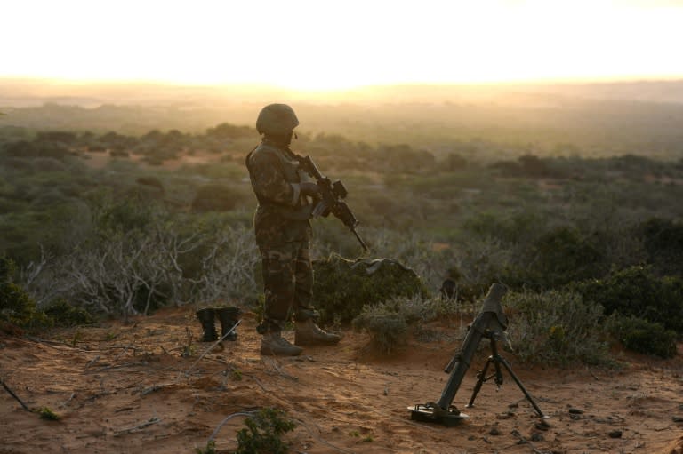 A handout image made available by the African Union Mission to Somalia (AMISOM) on October 6, 2014, shows a soldier belonging to the African Union Mission in Somalia, standing on the top of a hill next to the al-Shabab stronghold of Barawe