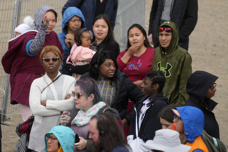 People wait a meeting with Pope Francis at Nakasuk Elementary School Square in Iqaluit, Canada, Friday, July 29, 2022. Pope Francis travels to chilly Iqaluit, capital of northern Nunavut, to meet with Inuit Indigenous people, including school children and survivors of residential schools, in his final day in Canada. (AP Photo/Gregorio Borgia)