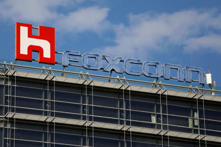 FILE PHOTO: The logo of Foxconn, the trading name of Hon Hai Precision Industry, is seen on top of the company's building in Taipei, Taiwan, March 30, 2018. REUTERS/Tyrone Siu/File Photo