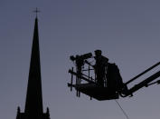 FILE - A television camera is silhouetted against the darkening sky outside St Giles Cathedral where Queen Elizabeth's coffin arrived earlier in the day, in Edinburgh, Scotland, Monday, Sept. 12, 2022. Plans by news organizations that have been in place for years — even decades — to cover the death of Queen Elizabeth II were triggered and tested when the event took place. London has been inundated with journalists, with more headed to the city for the funeral services on Monday. (AP Photo/Jon Super, File)