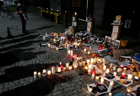 A man with a child attend a protest in support of Alfie Evans, in front of the British Embassy building in Warsaw, Poland April 26, 2018. REUTERS/Kacper Pempel