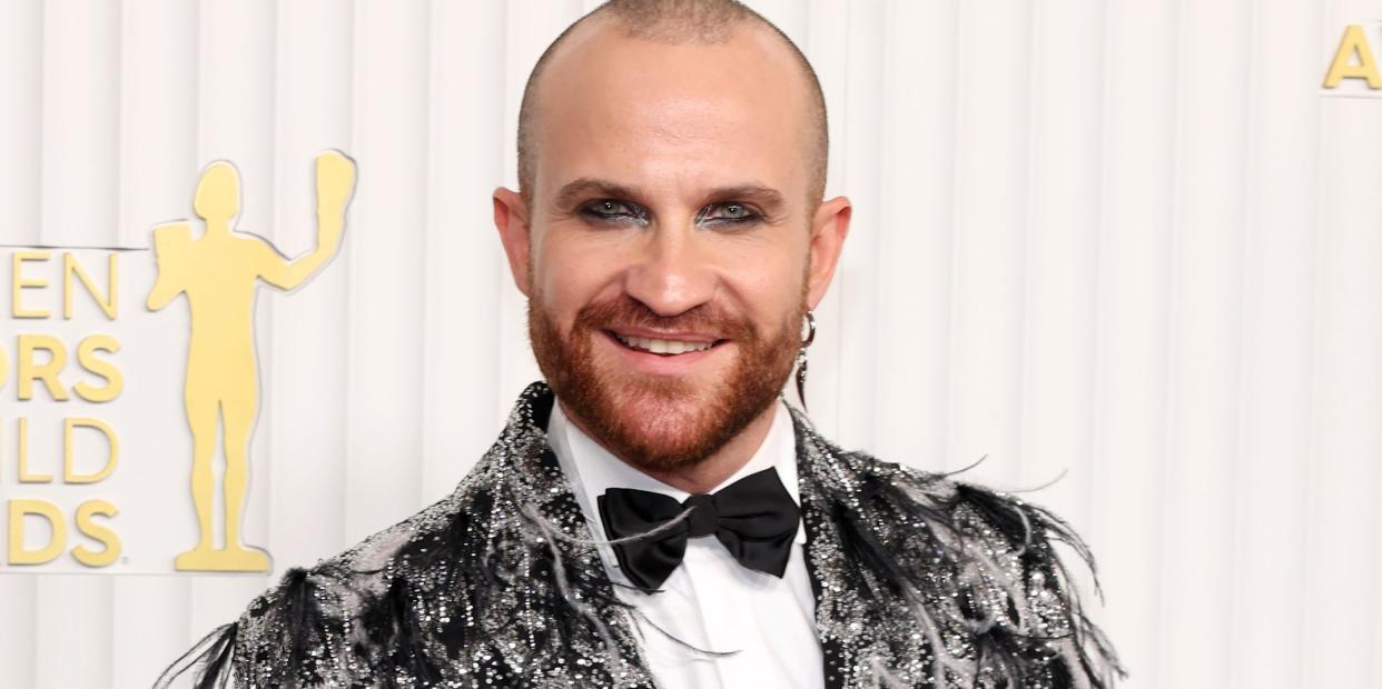 paolo camilli in a black tux embellished feathers and sequins