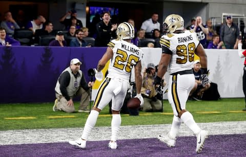 New Orleans Saints cornerback P.J. Williams (26) celebrates with teammate Sheldon Rankins after returning an interception 45-yards for a touchdown - Credit: AP Photo/Jim Mone