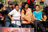 The cast of the MMFF 2012 entry "The Strangers" are seen riding their festival float as it makes its way through the crowd at the 2012 Metro Manila Film Festival Parade of Stars on 23 December 2012.(Angela Galia/NPPA Images)