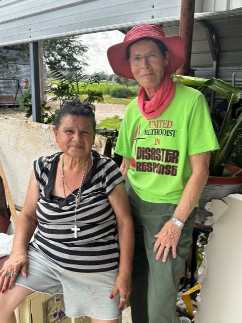 Alicia Rocha and volunteer Paula Cook outside Rocha’s home in Hereford, where mold remediation is taking place after flooding caused damage to the area in May.