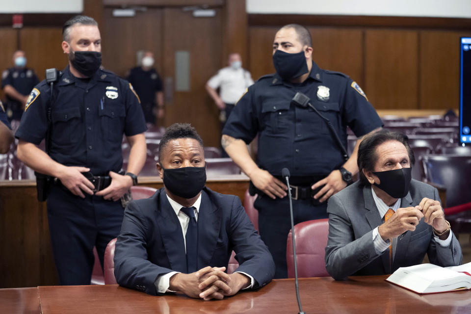 FILE - In this Aug. 13, 2020 file photo, Cuba Gooding Jr., front left, sits at the defense table with his lawyer Marc Heller, during a hearing in his sexual misconduct case in New York. U.S. District Judge Paul Crotty issued a default judgment against Gooding on Thursday, July 29, 2021, saying it appeared the Oscar-winning "Jerry Maguire" star was willfully ignoring the lawsuit and that waiting for him any longer would be unfair to his accuser. Crotty said that under the law, the 53-year-old Gooding's failure to respond and defend himself in the lawsuit constituted an admission of liability. (Steven Hirsch/New York Post via AP, Pool, File)