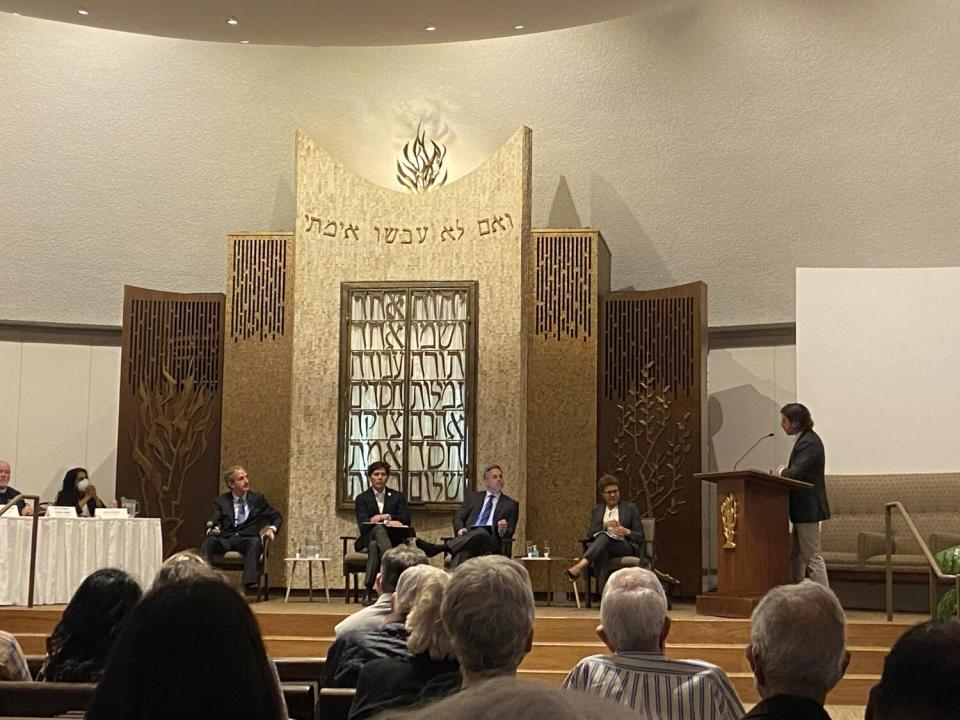 Mayoral candidates sit onstage