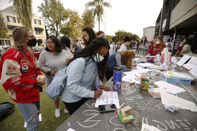 LOS ANGELES, CA - OCTOBER 22: USC junior student Paige Hewlett makes a sign to attach to the Sigma Nu fraternity house near the USC campus. USC officials have placed the Sigma Nu fraternity chapter on interim suspension following allegations that women were drugged and sexually assaulted at the fraternity house. In a crime alert issued Thursday, the USC Department of Public Safety said campus officials received "a report of sexual assault" at the Sigma Nu fraternity house locate at 660 W. 28th St. "The university also has received reports of drugs being placed into drinks during a party at the same fraternity house, leading to possible drug-facilitated sexual assaults," according to the alert. USC on Friday, Oct. 22, 2021 in Los Angeles, CA. (Al Seib / Los Angeles Times).