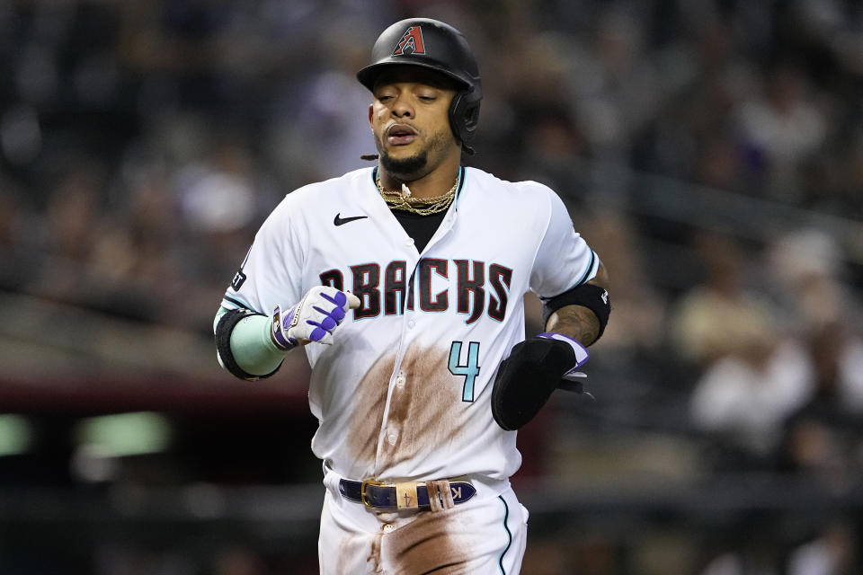 Arizona Diamondbacks' Ketel Marte (4) scores on a base hit by Emmanuel Rivera during the first inning of a baseball game against the Colorado Rockies, Tuesday, Sept. 5, 2023, in Phoenix. (AP Photo/Matt York)