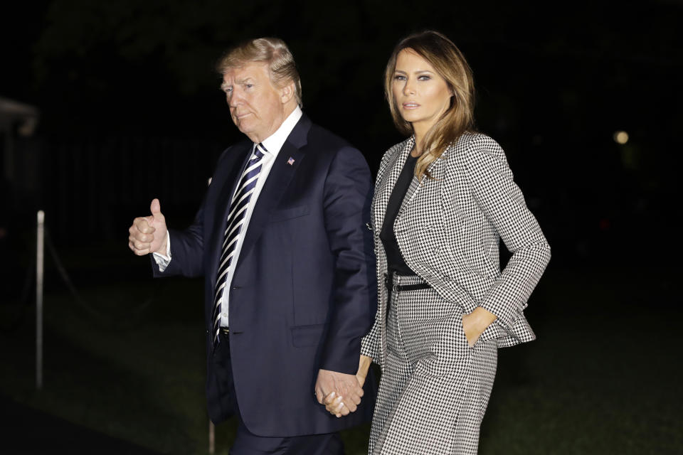 <p>President Donald Trump, left, gives a thumbs-up as he walks with First Lady Melania Trump on the South Lawn of the White House after landing on Marine One following an event at Joint Base Andrews in Washington on Thursday, May 10, 2018. (Photo: Yuri Gripas/Bloomberg via Getty Images) </p>