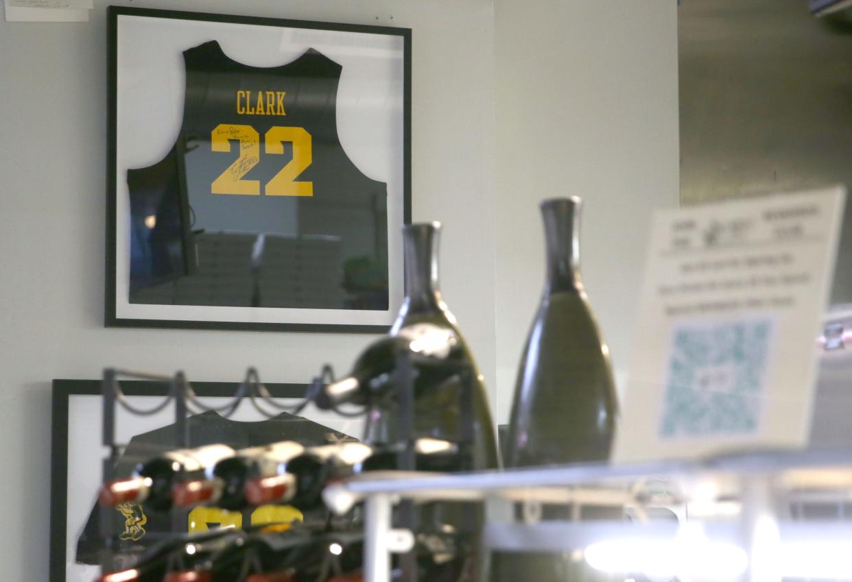 A signed Caitlin Clark jersey hangs on the wall Tuesday, March 26, 2024 at Graze Gourmet To Go in Iowa City, Iowa.