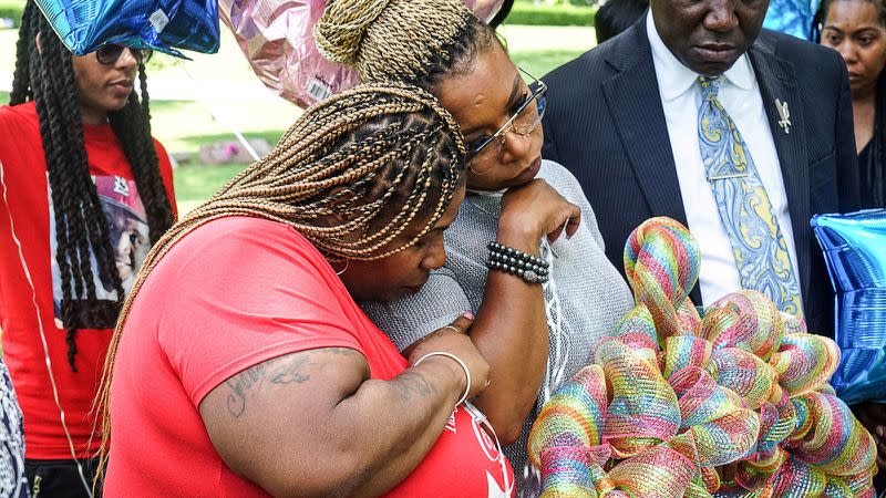 FILE PHOTO: Samaria Rice mother of Tamir Rice comforts Lezley McSpadden, mother of Michel Brown Jr., at his gravesite on the 5-year anniversary of his passing in Normandy