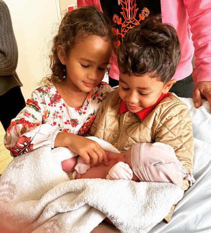Chrissy Teigen Instagram Luna and Miles hold their little sister, Esti