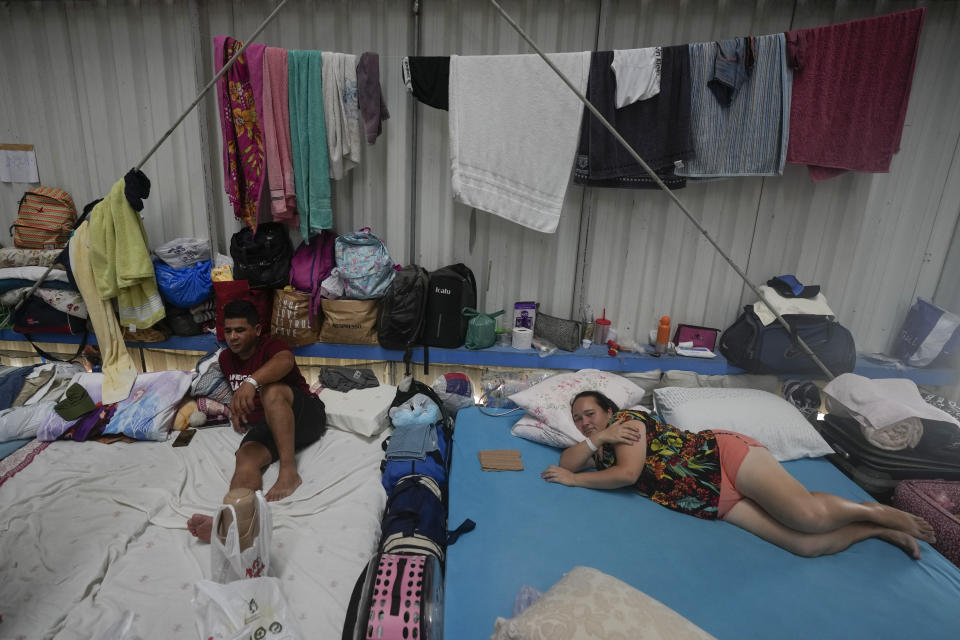 People who evacuated their flooded homes rest in a shelter amid heavy rain in Porto Alegre, Rio Grande do Sul state, Brazil, Wednesday, May 8, 2024. (AP Photo/Andre Penner)