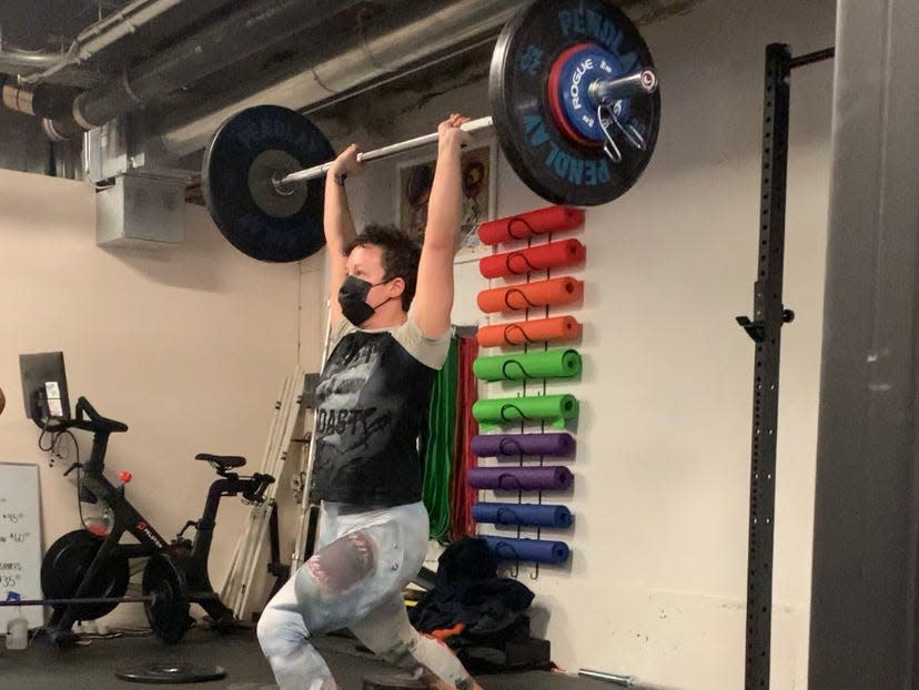 fitness reporter Gabby Landsverk completely a clean and jerk weightlifting exercise