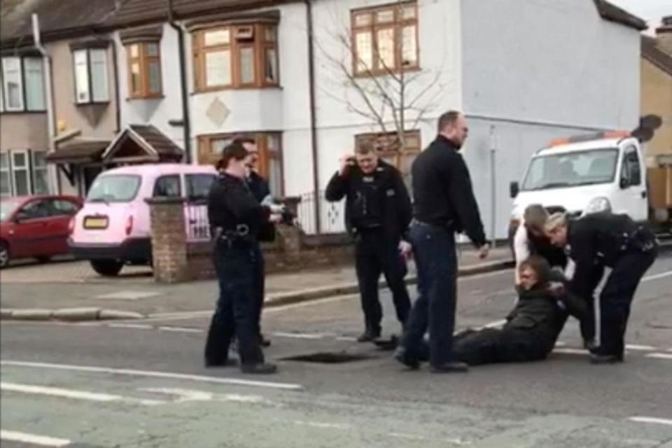 Police haul the cold, injured man from the drain in Romford