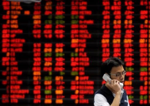 An investor stands in front of an electronic shares price display in Bangkok, 2008. Asian markets and the euro surged after eurozone leaders struck a deal to allow the bloc's bailout fund to directly support struggling banks and pledged $150 billion to boost growth