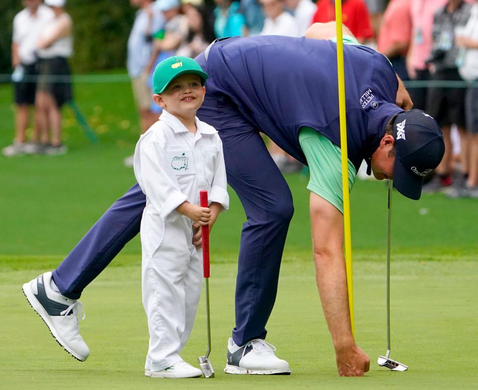 Apr 6, 2022; Augusta, Georgia, USA; Hudson Swafford's son, James, 3, smiles and thanks the crowd after they applaud him for sinking a putt on no. 5 during the Par 3 Contest at The Masters golf tournament at Augusta National Golf Club.