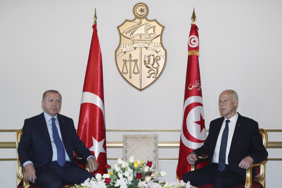 Turkey's President Recep Tayyip Erdogan, left, and Tunisian President Kais Saied pose during a meeting, in Tunis, Tunisia, Wednesday, Dec. 25, 2019. Erdogan with top Turkish officials is on an unannounced visit to Tunisia to meet Saied.(Turkish Presidency via AP, Pool)