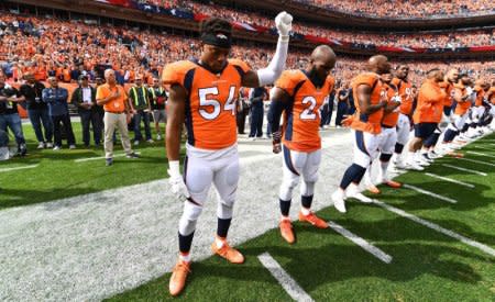 Oct 1, 2017; Denver, CO, USA; Denver Broncos inside linebacker Brandon Marshall (54) and free safety Darian Stewart (26) react along with teammates during the American national anthem before a game against the Oakland Raiders at Sports Authority Field at Mile High. Mandatory Credit: Ron Chenoy-USA TODAY Sports