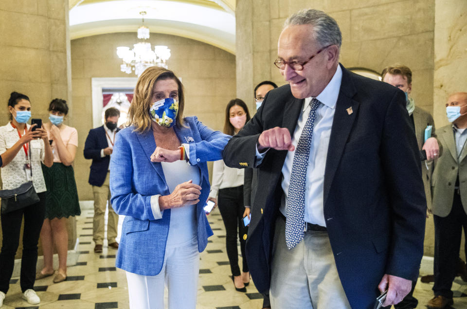 House Speaker Nancy Pelosi of Calif., gives Senate Minority Leader Chuck Schumer of N.Y., an elbow bump as Schumer leaves following a meeting at the Capitol with White House chief of staff Mark Meadows and Treasury Secretary Steven Mnuchin on a COVID-19 relief bill, Saturday, Aug. 1, 2020, in Washington. (AP Photo/Manuel Balce Ceneta)