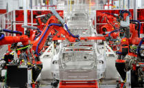 FILE PHOTO -- Robotic arms assemble Tesla's Model S sedans at the company's factory in Fremont, California, June 22, 2012. REUTERS/Noah Berger/File Photo