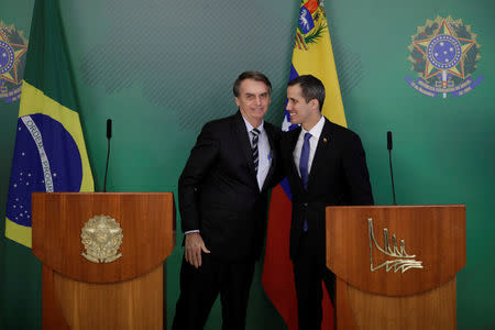 Venezuelan opposition leader Juan Guaido greets Brazil's President Jair Bolsonaro after a meeting in Brasilia, Brazil February 28, 2019. REUTERS/Ueslei Marcelino