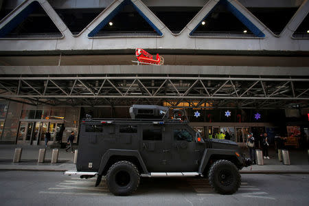 An armored vehicle belonging to the New York Port Authority sits beneath a Christmas decoration at the entrance of the New York Port Authority Bus Terminal following an attempted detonation during the morning rush hour, in New York City, New York, U.S., December 11, 2017. REUTERS/Andrew Kelly