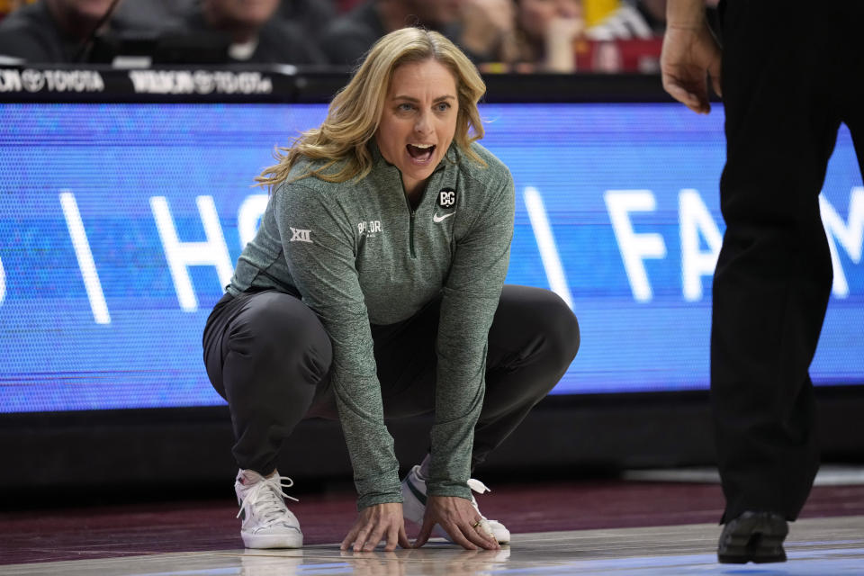 FILE - Baylor head coach Nicki Collen crouches on the sidelined during the second half of an NCAA college basketball game against Iowa State, Saturday, Feb. 4, 2023, in Ames, Iowa. The Baylor women won’t win the Big 12 regular-season title for the first time in 13 seasons or get to open the NCAA Tournament at home, ending what had also pretty much become a given over the past decade. But second-year coach Nicki Collen said the Bears will be OK. (AP Photo/Charlie Neibergall, File)