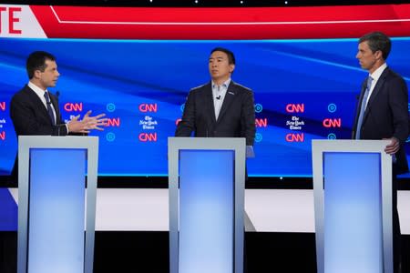 Democratic presidential candidate Buttigieg debates gun confiscation proposals with former Rep. Beto O'Rourke as entrepreneur Andrew Yang listens during the fourth U.S. Democratic presidential candidates 2020 election debate in Westerville, Ohio
