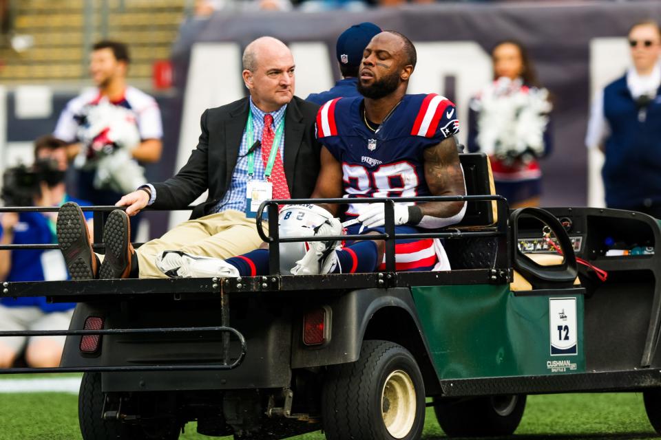 New England Patriots running back James White is carried off the field after a running play during a game against the New Orleans Saints on Sept. 26, 2021, at Gillette Stadium in Foxboro.