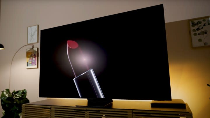 A backlit giant lipstick shown on a Samsung S95D OLED.