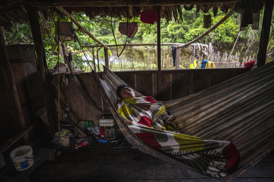 Maijuna Indigenous Justo Padilla sleeps in a hammock inside his home in Sucusari, Peru, Thursday, May 30, 2024. A federal highway project in an untouched area of the Peruvian Amazon is facing mounting opposition from Indigenous tribes, including the Maijuna. (AP Photo/Rodrigo Abd)