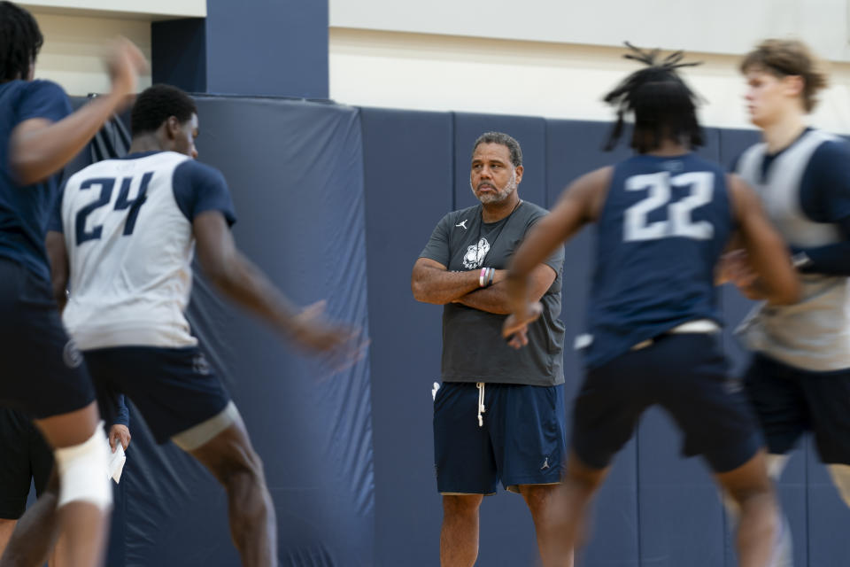 Georgetown NCAA college basketball head coach Ed Cooley, center, watches while players run drills during practice, Thursday, Oct. 19, 2023, in Washington. (AP Photo/Stephanie Scarbrough)