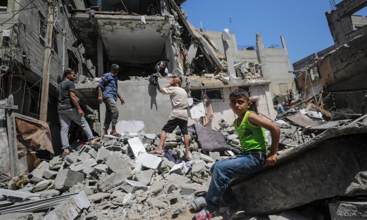 <span>Palestinians search for missing people under the rubble of a destroyed house after an Israeli airstrike in June.</span><span>Photograph: Mohammed Saber/EPA</span>