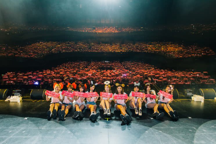 TWICE taking a photo with the crowd at their first concert in Singapore (Photo: ONE Production)