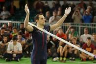 Renaud Lavillenie of France raises his arms to the crowd before attempting to set a world record during the men's pole vault event at the IAAF World Indoor Athletics Championships in Portland, Oregon March 17, 2016. REUTERS/Mike Blake